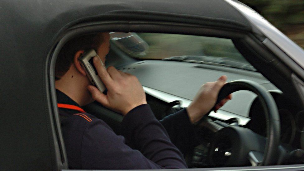 Man using his phone while driving