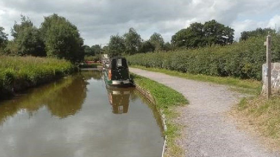 A narrowboat with the opening to the Llangollen canal (and the lift bridge) in the distance