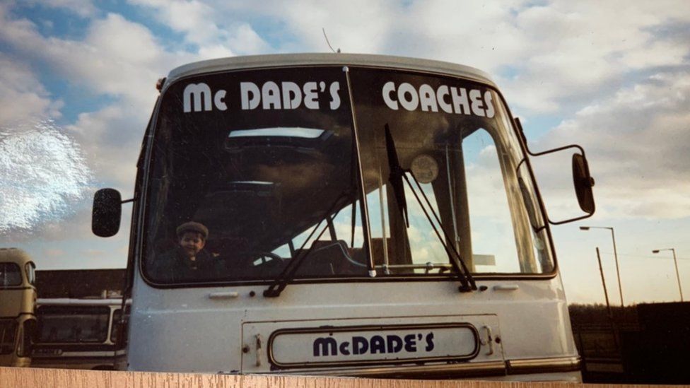 Andy McDade at wheel of coach when he was a toddler