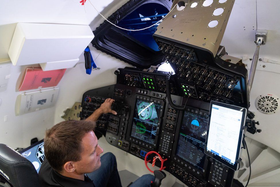 Starliner's flight controls are suspended above the front two seats