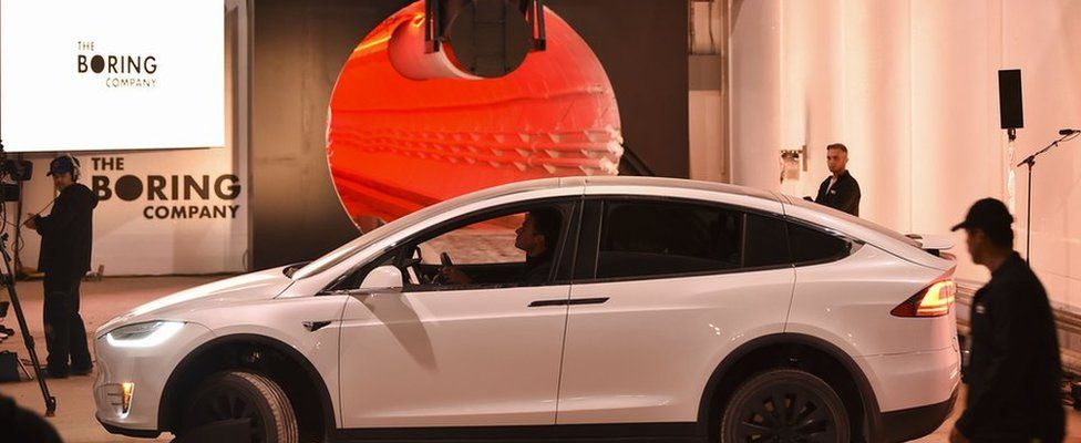 A modified Tesla Model X electric vehicle prepares to enter a tunnel during an unveiling event for The Boring Company Hawthorne test tunnel December 18, 2018