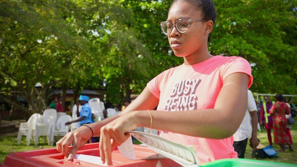 A young woman voting