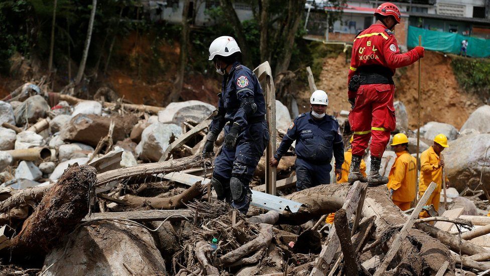 Rescuers look for bodies in a destroyed area after flooding and mudslides caused by heavy rains in Mocoa