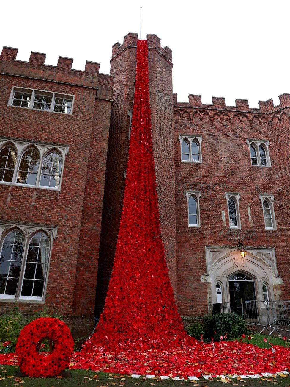 More than 15,000 poppies - knitted by the Secret Society of Hertford Crafters as well as schoolchildren and people in care homes, pour down Hertford Castle