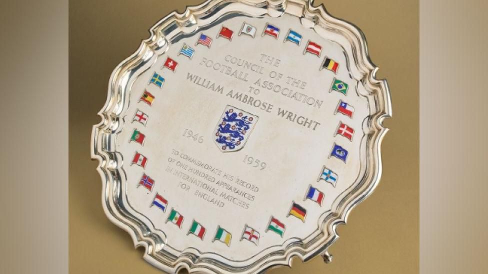 The silver salver with a ring of flags around the outside