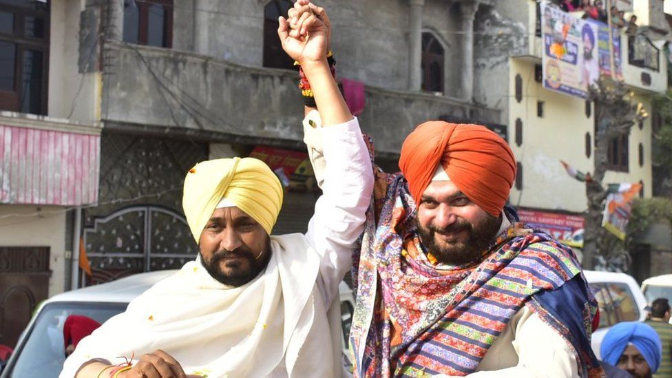 Punjab Chief Minister Charanjit Singh Channi with Punjab Congress President and candidate from Amritsar East Constituency Navjot Singh Sidhu during a road show campaign ahead of Punjab assembly election on February 17, 2022 in Amritsar, India.