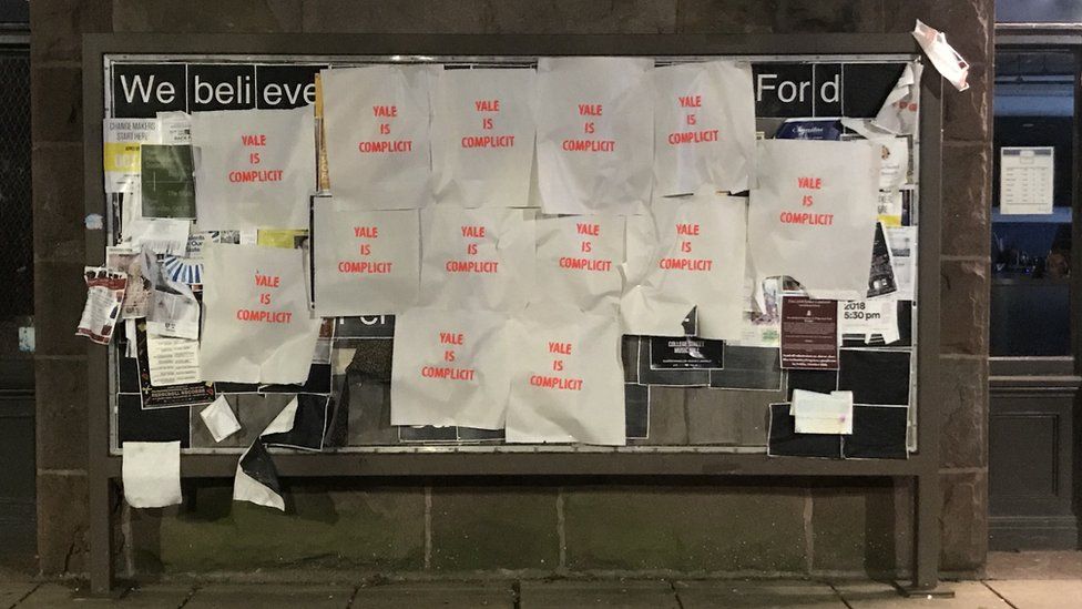 Photo of posters saying "Yale is complicit" at Yale