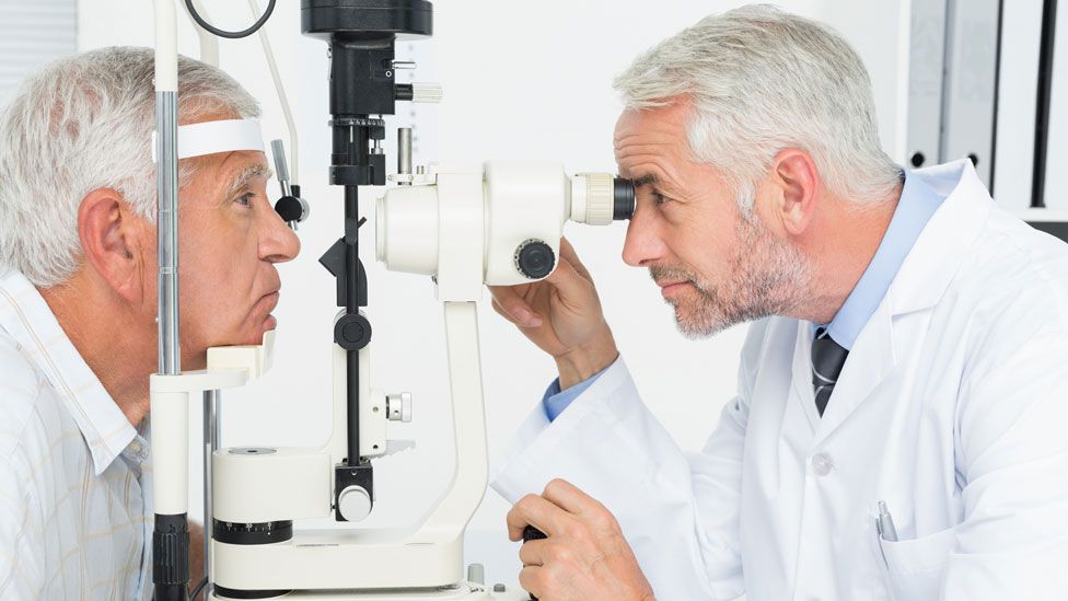 Optician examining patient