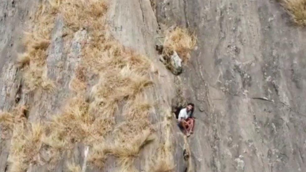 Kerala trekker R Babu is seen trapped in the cleft of a hill.