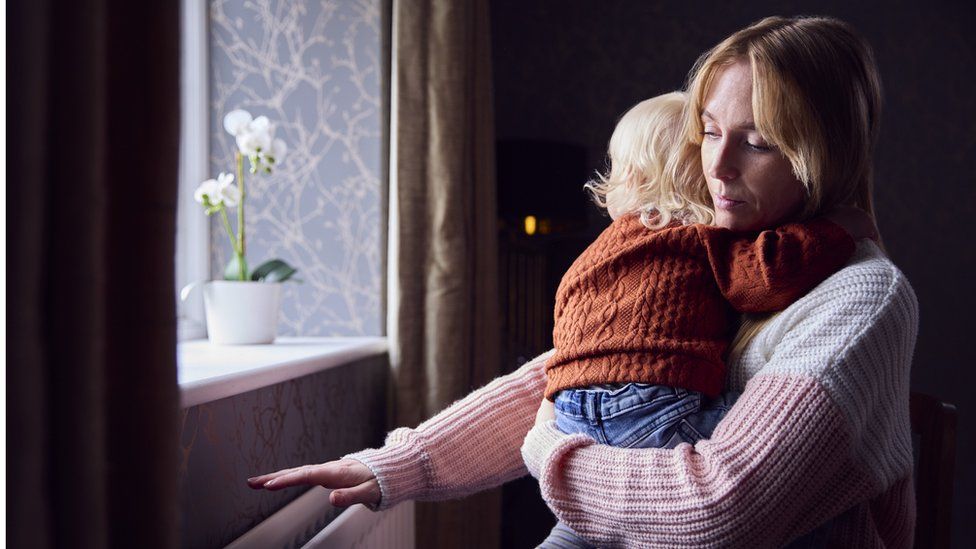 Woman and child with radiator - stock shot