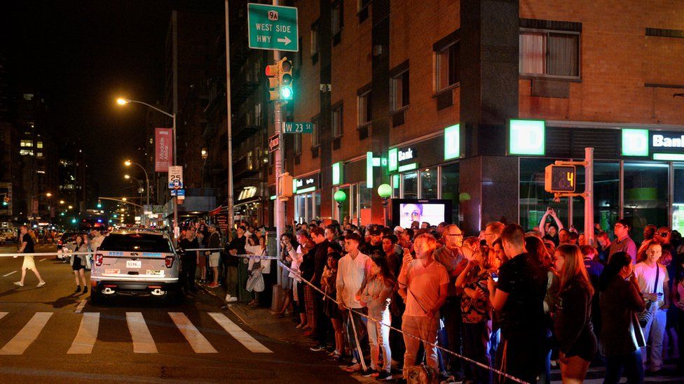 Onlookers behind police cordon near scene of explosion in Chelsea, New York, on 17 September 2016