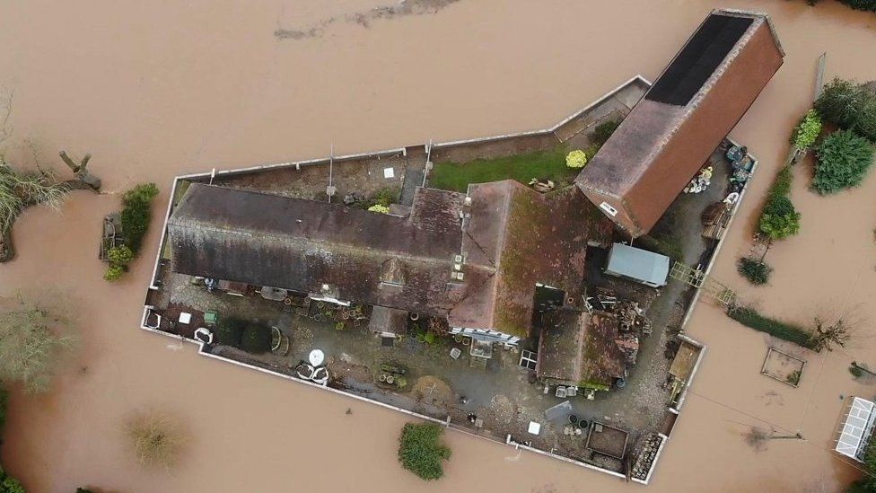 A wall circling Nick Lupton's property protects it against floods