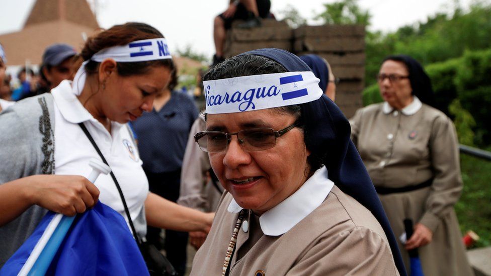 Nuns are seen wearing headbands in the country's national colours
