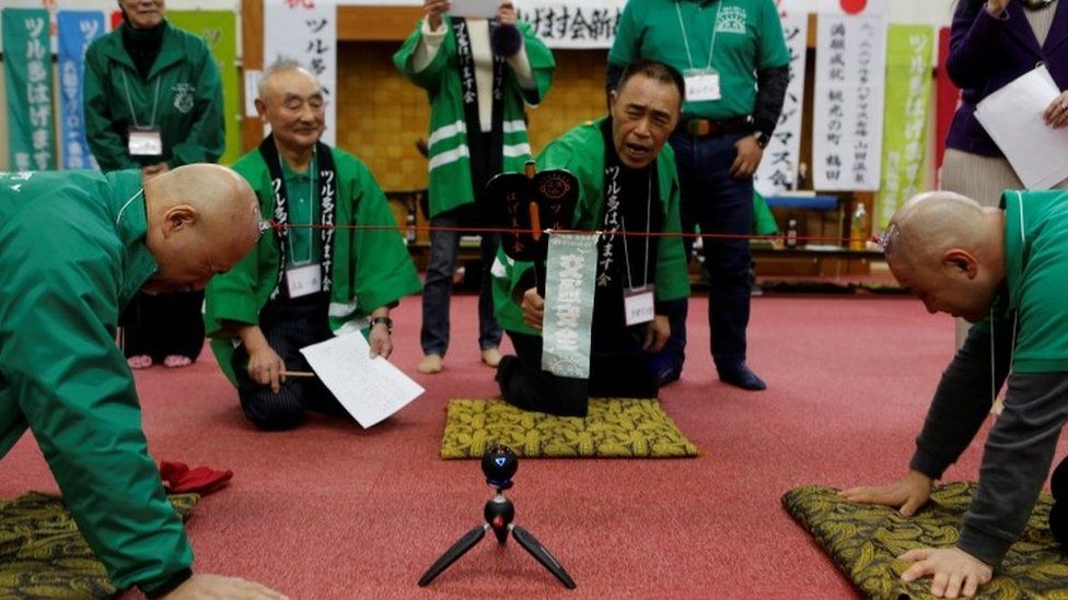 Japanese Bald Men Club members participate in a tug-of-war contest (22 February 2017)