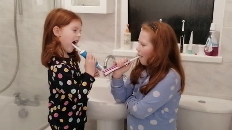 Two of Jodi Hayes' children brushing their teeth