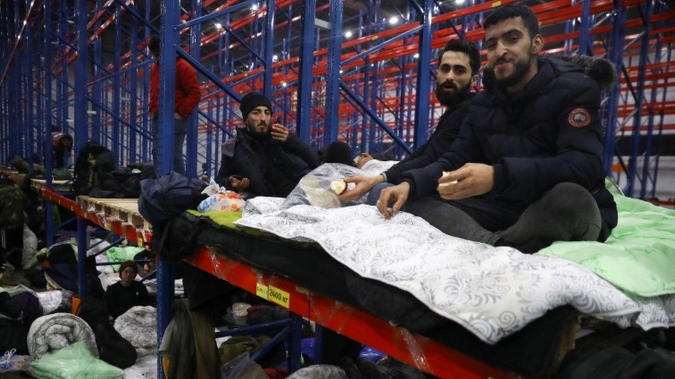 Migrants gather at a transport and logistics centre near the Belarusian-Polish border