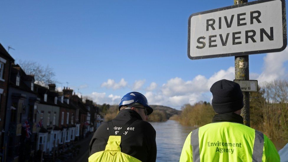 Environment Agency workers monitor the swollen River Severn in Bewdley