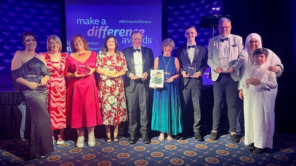 The winners from this year's Make a Difference awards hold their awards