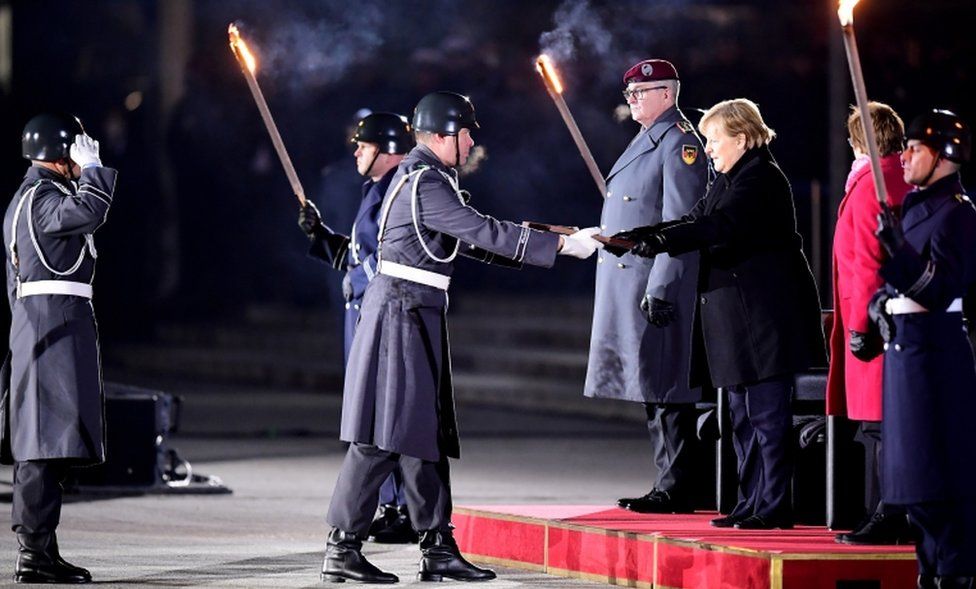 German Chancellor Angela Merkel (R) during the military grand tattoo in her honour at the defence ministry in Berlin, Germany, 02 December 2021