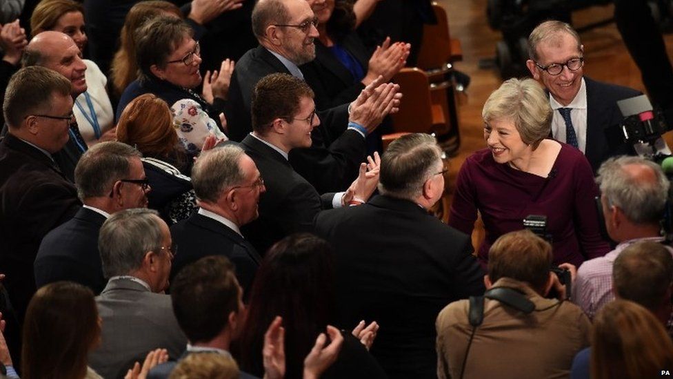 Theresa May is greeted by supporters after the speech