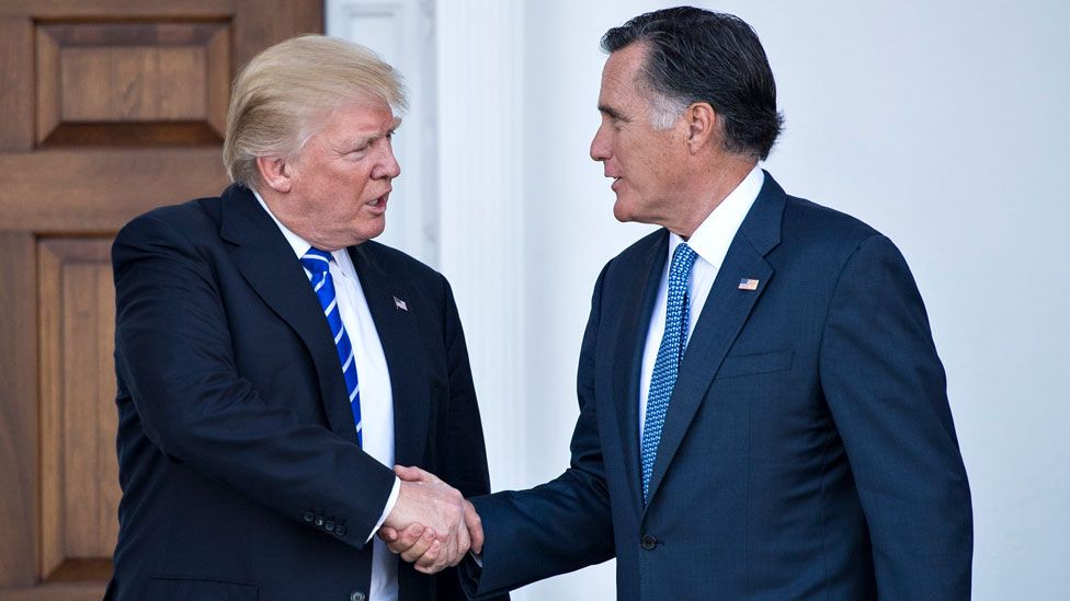 Donald Trump shakes hands with Mitt Romney