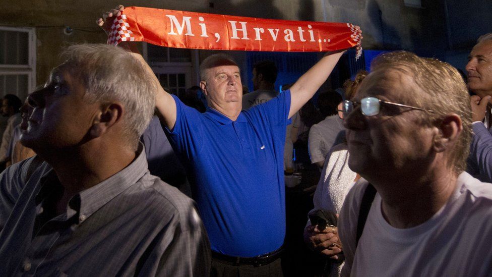 HDZ supporter with banner reading "We, Croats!"