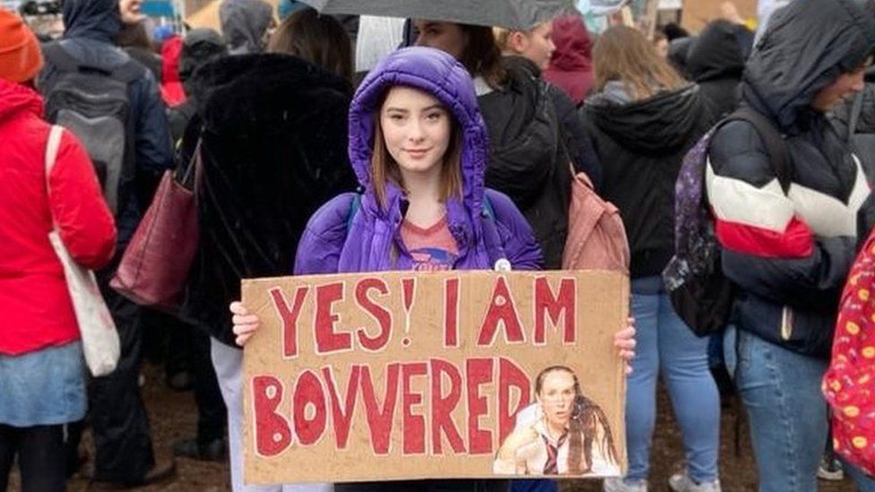 Poppy Stowell-Evans holding a placard at a protest