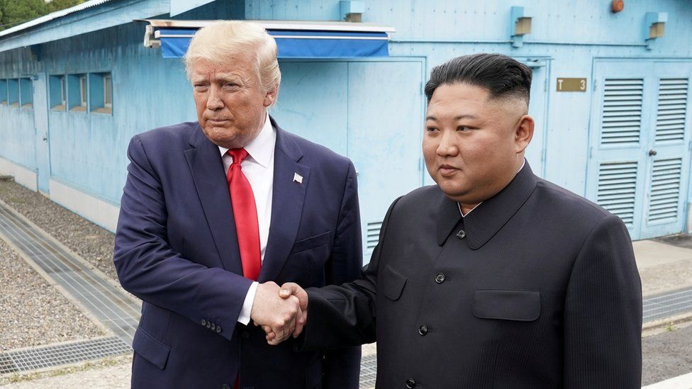 Trump shakes hands with Kim