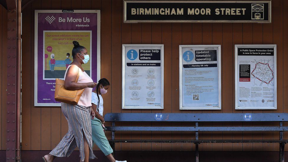People at a train station in Birmingham