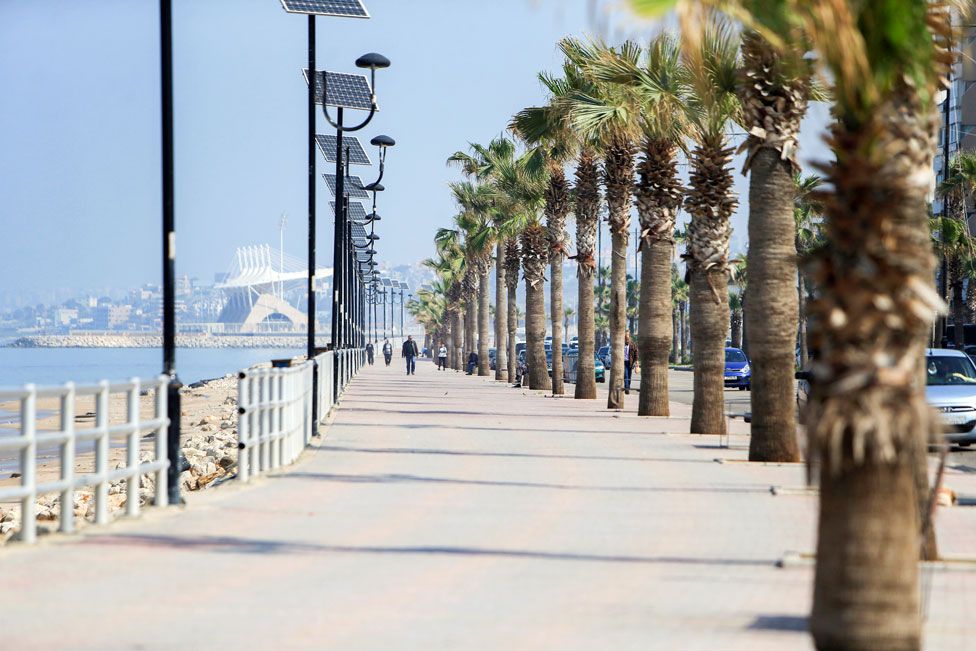 People walk along the empty Corniche in Sidon, Lebanon