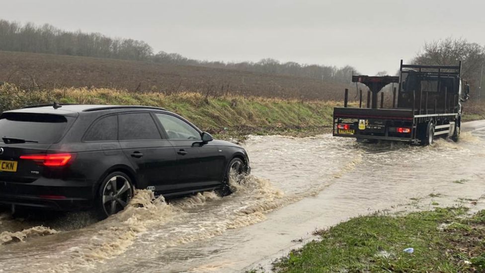 Vehicles driving through a flood