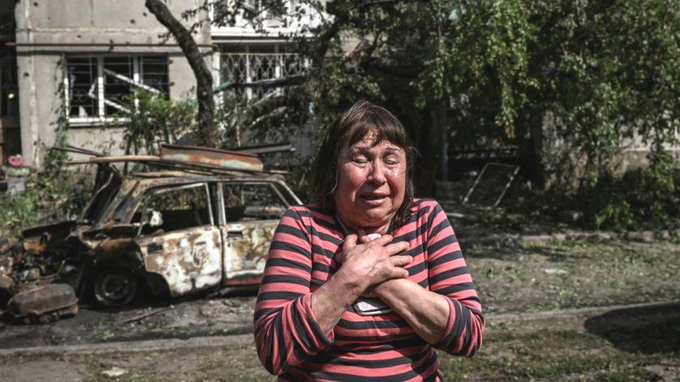 A woman outside her damaged apartment in Sloviansk, eastern Ukraine