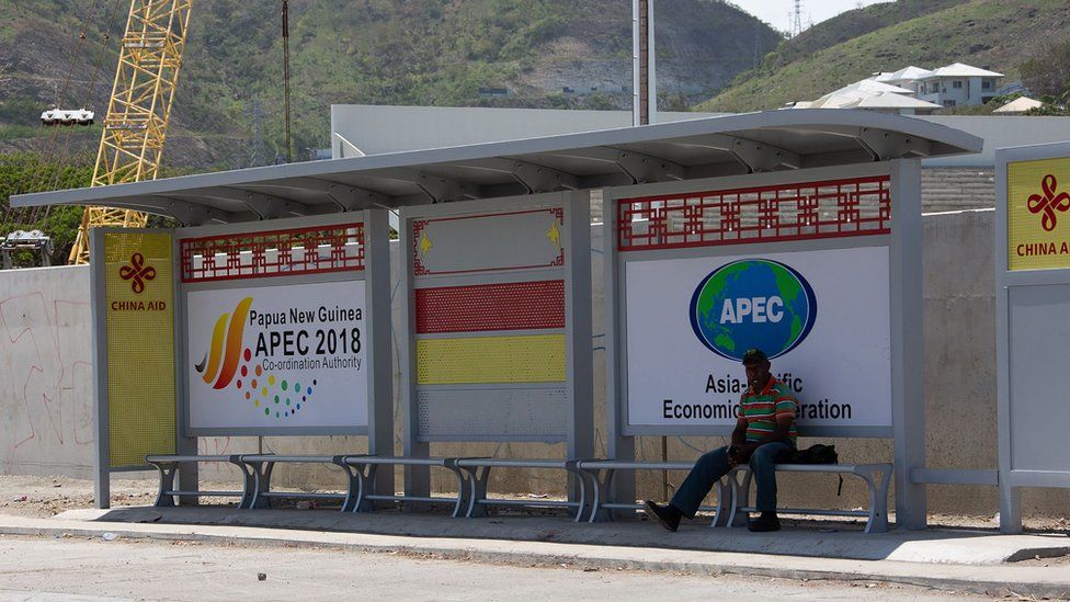 Chinese aid branding and APEC ads on a bus stop in Port Moresby