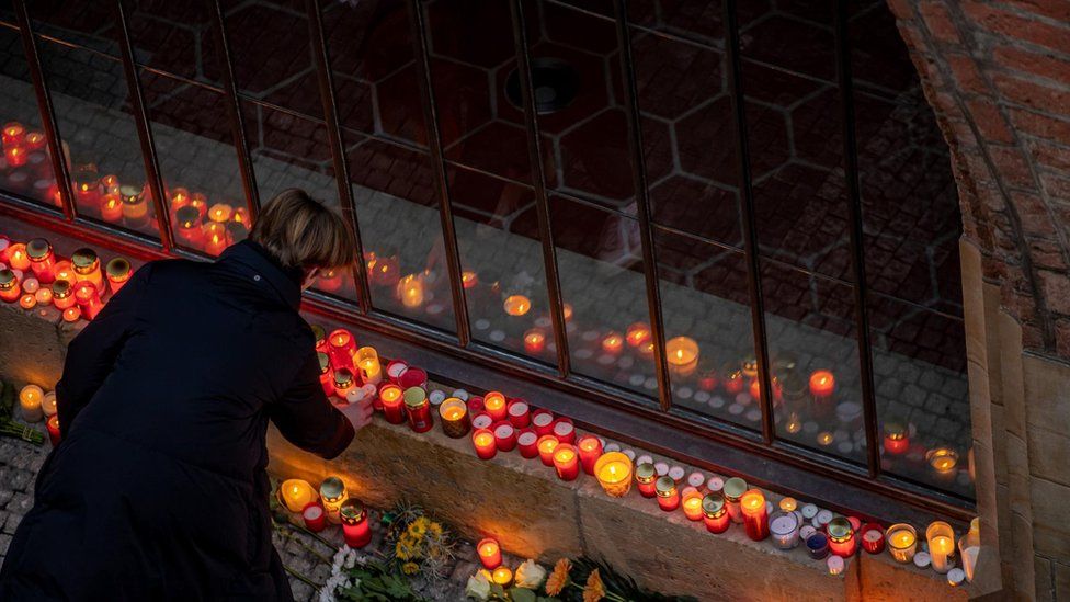 A person pays their respect in front of the university's main building following a mass shooting at the building of Philosophical Faculty of Charles University in central Prague