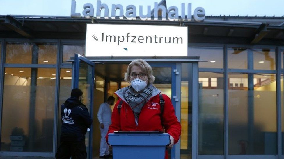 A worker with Covid vaccines sets out to inoculate patients in Dillenberg, Germany