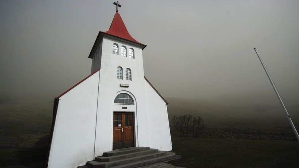 Smoke and ash from the Eyjafjallajokull volcano block daylight on a church 19 April 2010