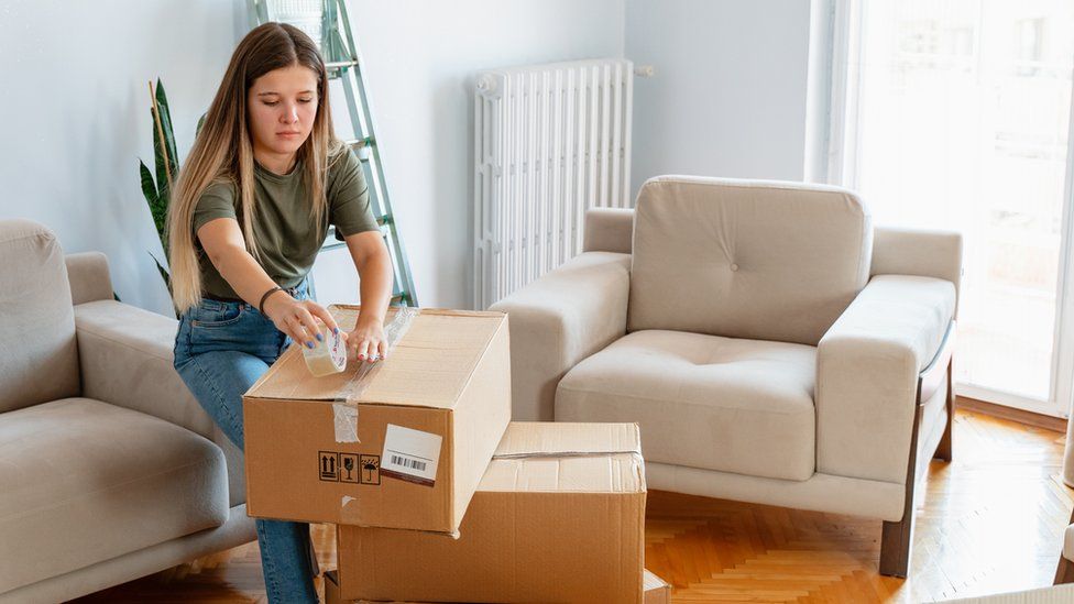 Woman unpacking boxes in a flat
