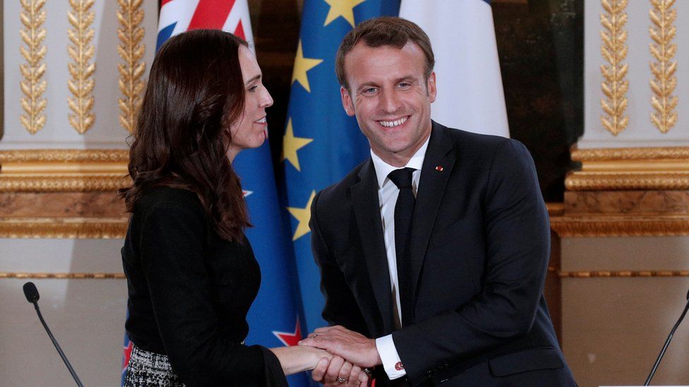 French President Emmanuel Macron greets New Zealand's Prime Minister Jacinda Ardern at the Elysee Palace in Paris