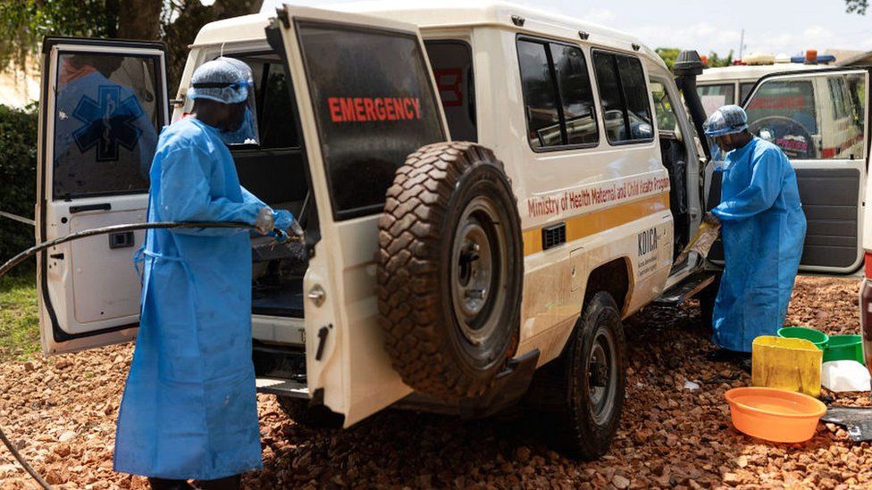 Health workers cleaning out medical vehicle
