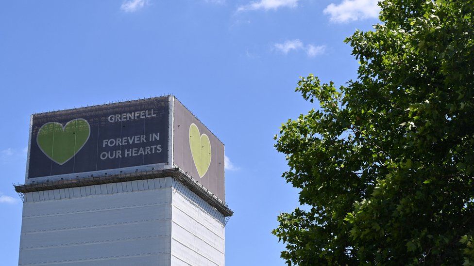 Grenfell Tower with the words Forever in our hearts.