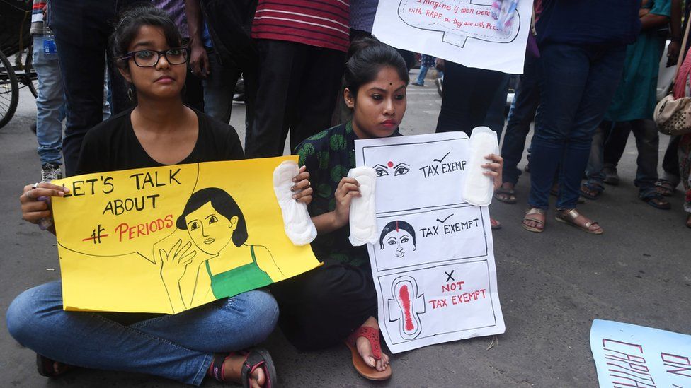 Indian students hold posters and sanitary napkins during a protest over a 12 per-cent tax on sanitary pads as part of the Goods and Services Tax (GST) in Kolkata on June 16, 2017