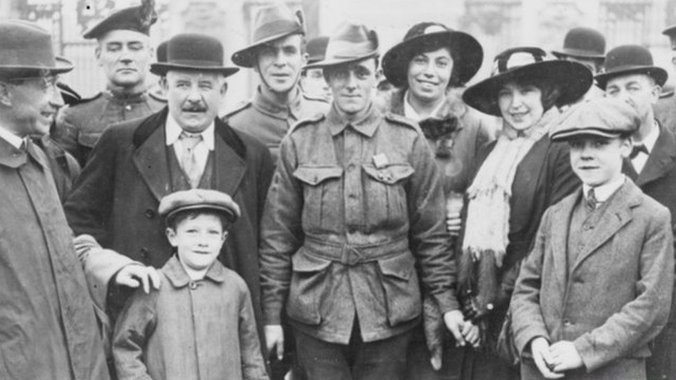 Pt John Leak surrounded by friends outside Buckingham Palace in November 1916