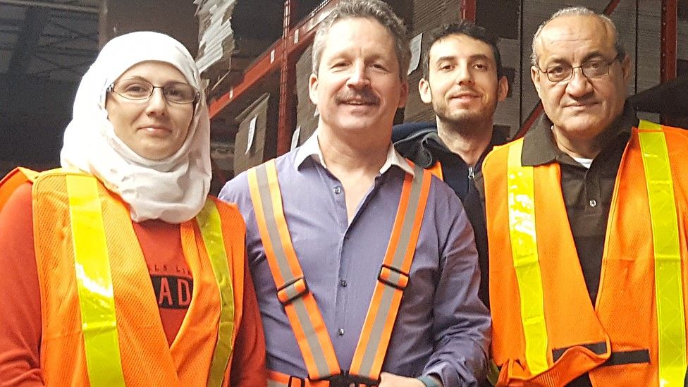 Jim Estill with some Syrian refugees who now work for Danby