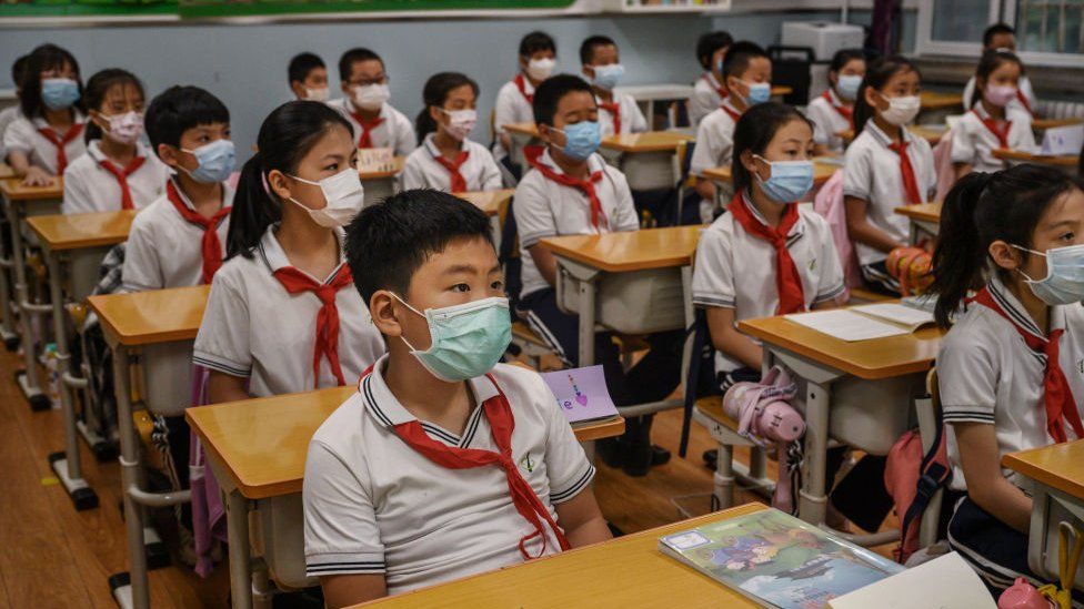 Chinese students in wear protective mask as they listen during a class