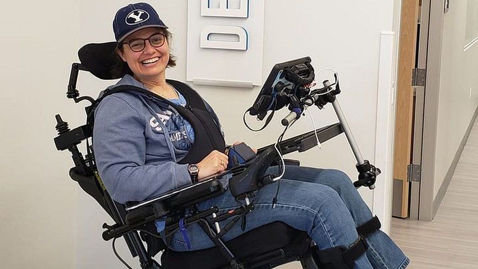 Sarah using a wheelchair smiling