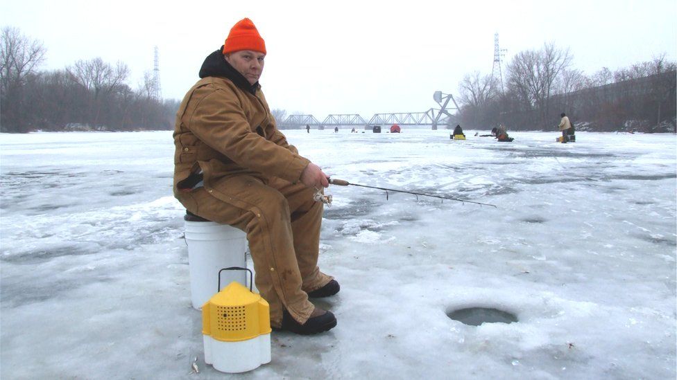 Thomas Darabos, fishing for walleye on the frozen Saginaw River