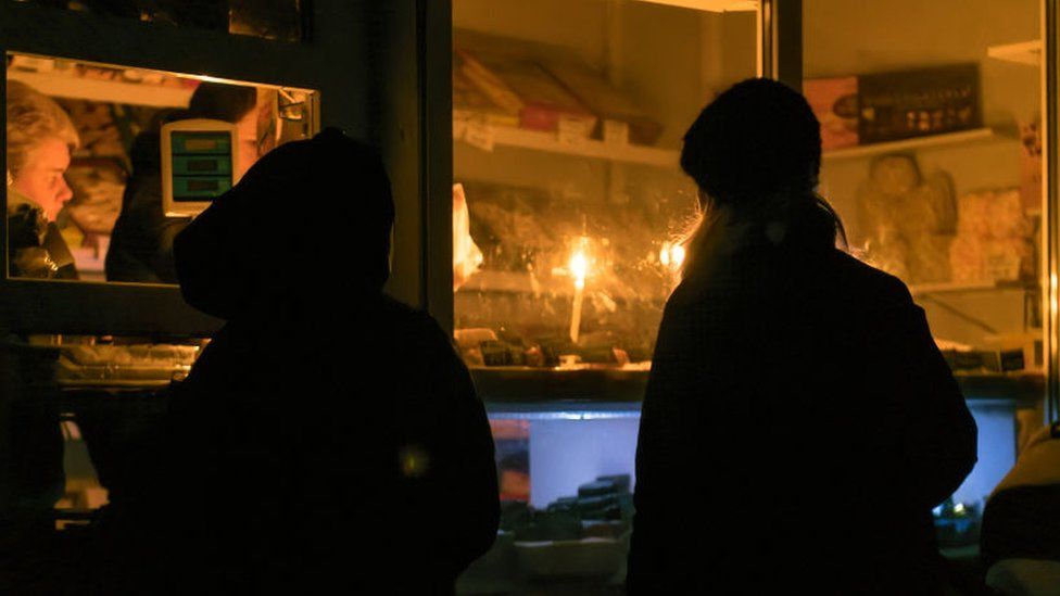 Small store operates by candlelight in town near Kyiv