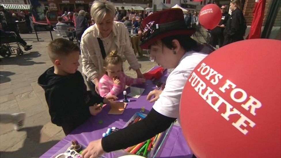 People at a stall at the Toys for Turkey campaign event