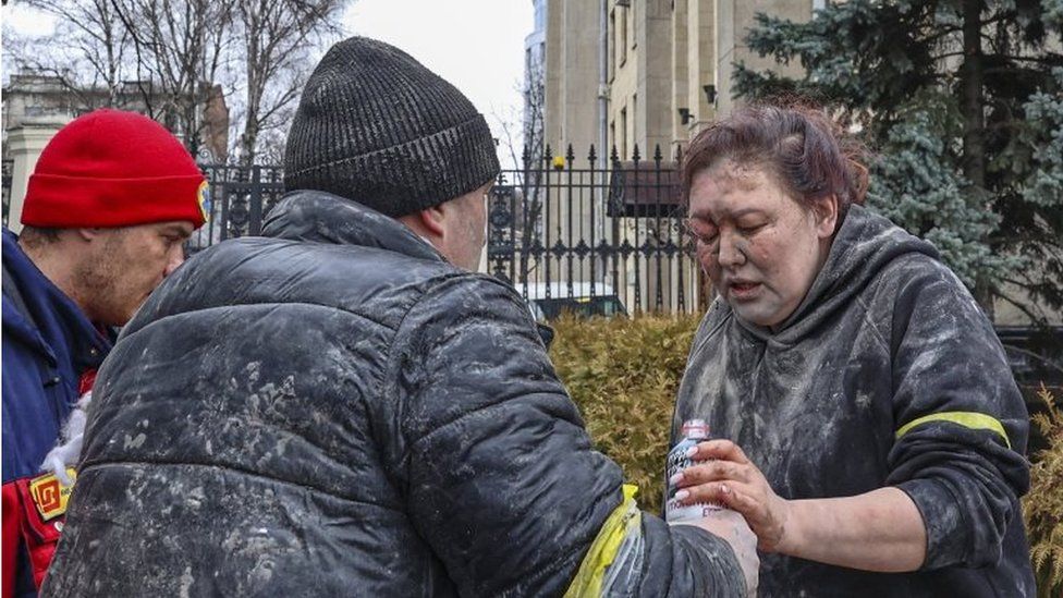 People help a wounded woman in the aftermath of a Russian shelling in Kharkiv, Ukraine, 01 March 2022.