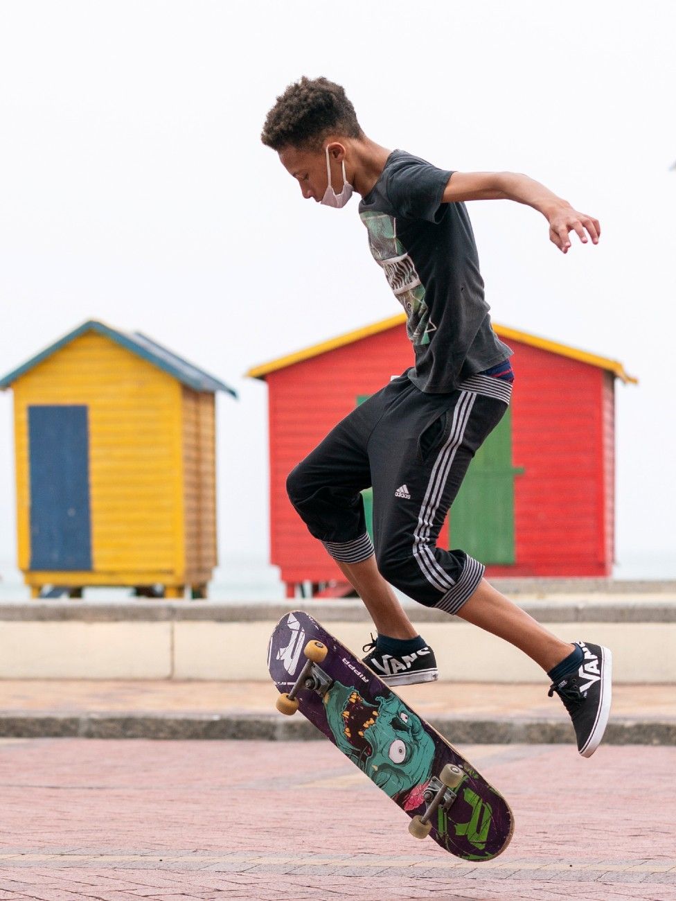 A man skateboarding next to the closed Muizenberg Beach in Cape Town, South Africa - Wednesday 25 March 2020